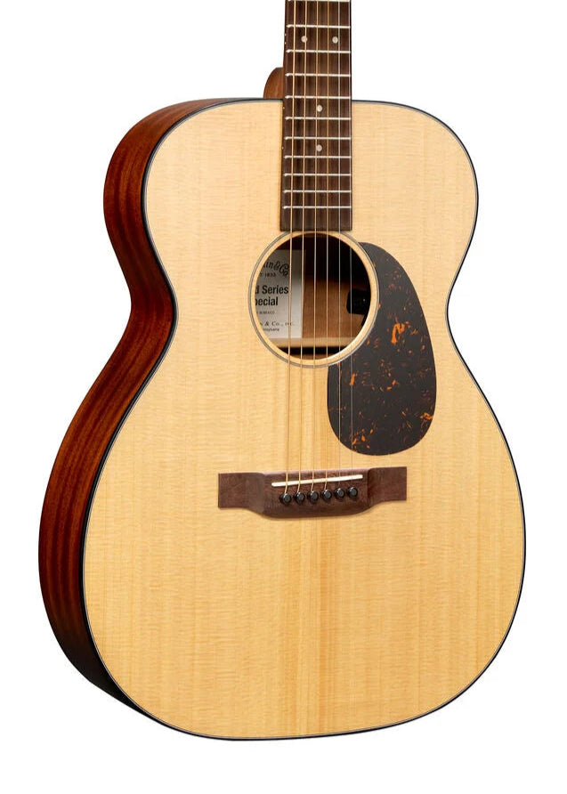 Acoustic guitar with a light wood top, dark brown sides, a tortoiseshell-pattern pickguard, and six strings attached to a wooden bridge.