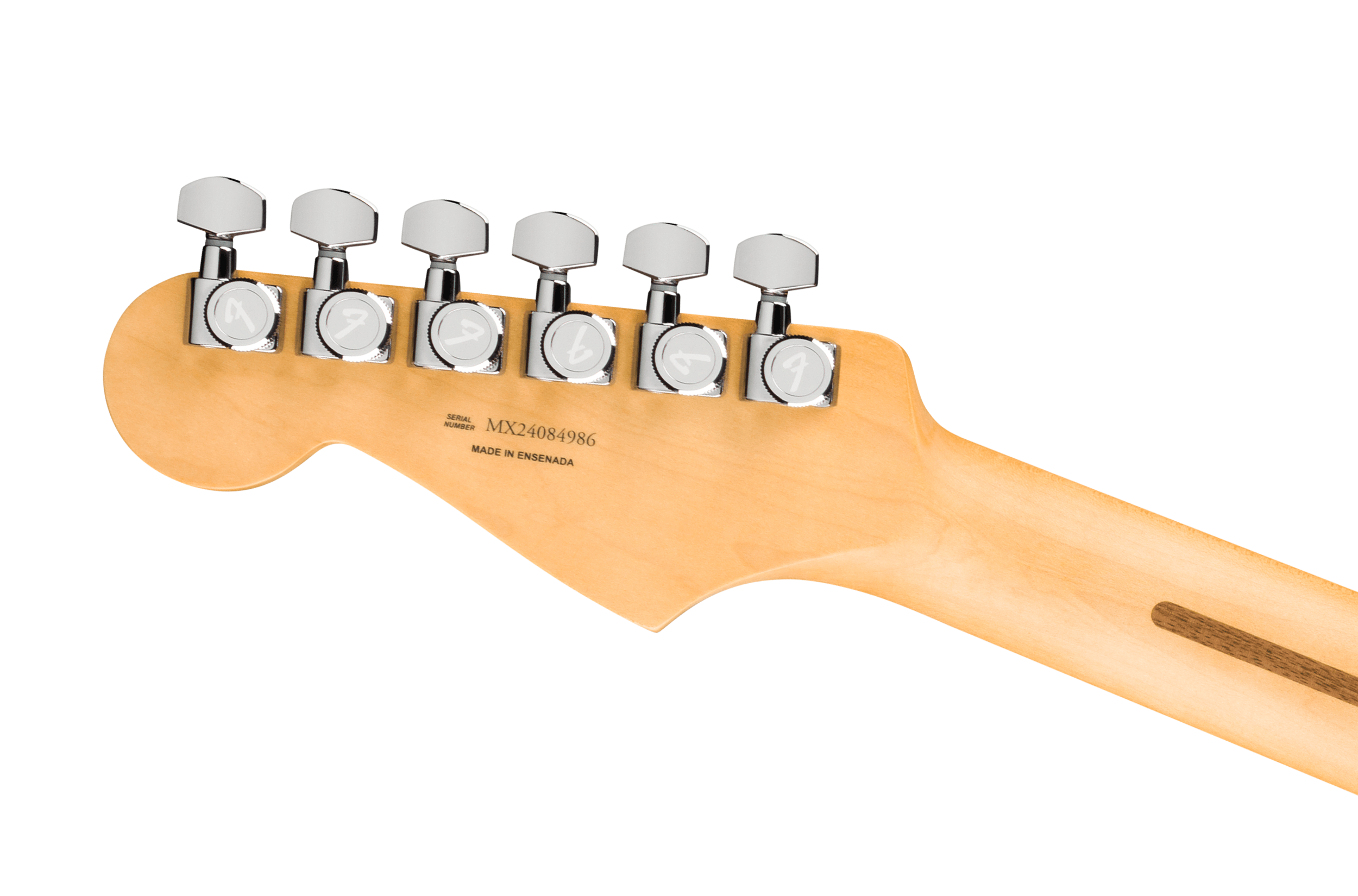 Six chrome tuning pegs with Fender logos line the light wood headstock of an electric guitar; serial number and "Made in Ensenada" are printed below.