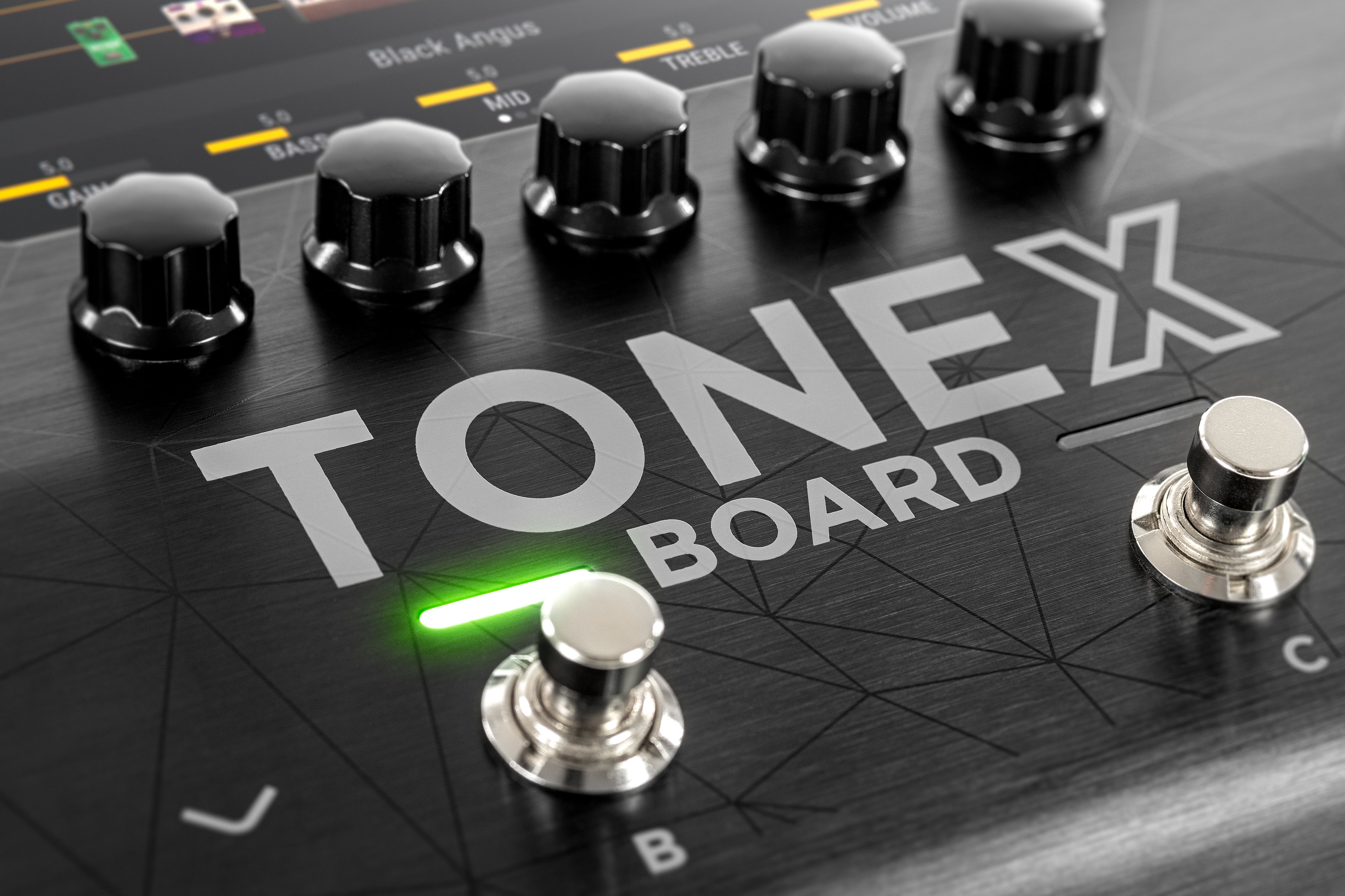 Black ToneX Board effects pedal with five control knobs, two footswitches, and a glowing green LED indicator above switch B.