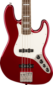 Glossy red electric bass with a white pickguard, four strings, black pickups, chrome bridge, and four control knobs on a silver plate.