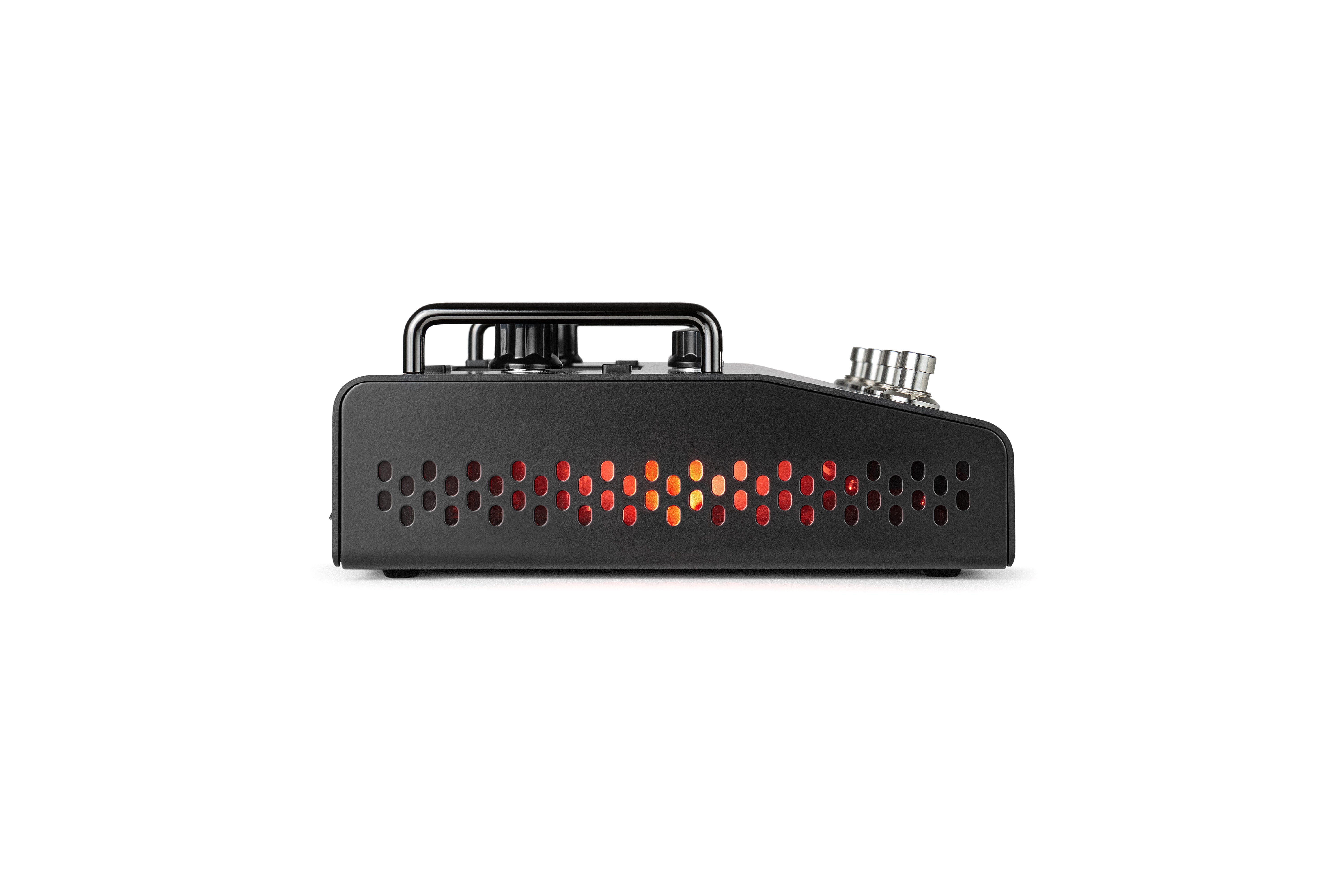 Black effects pedal with a row of oval ventilation holes showing glowing orange and red lights inside, top-mounted knobs and input jacks visible.