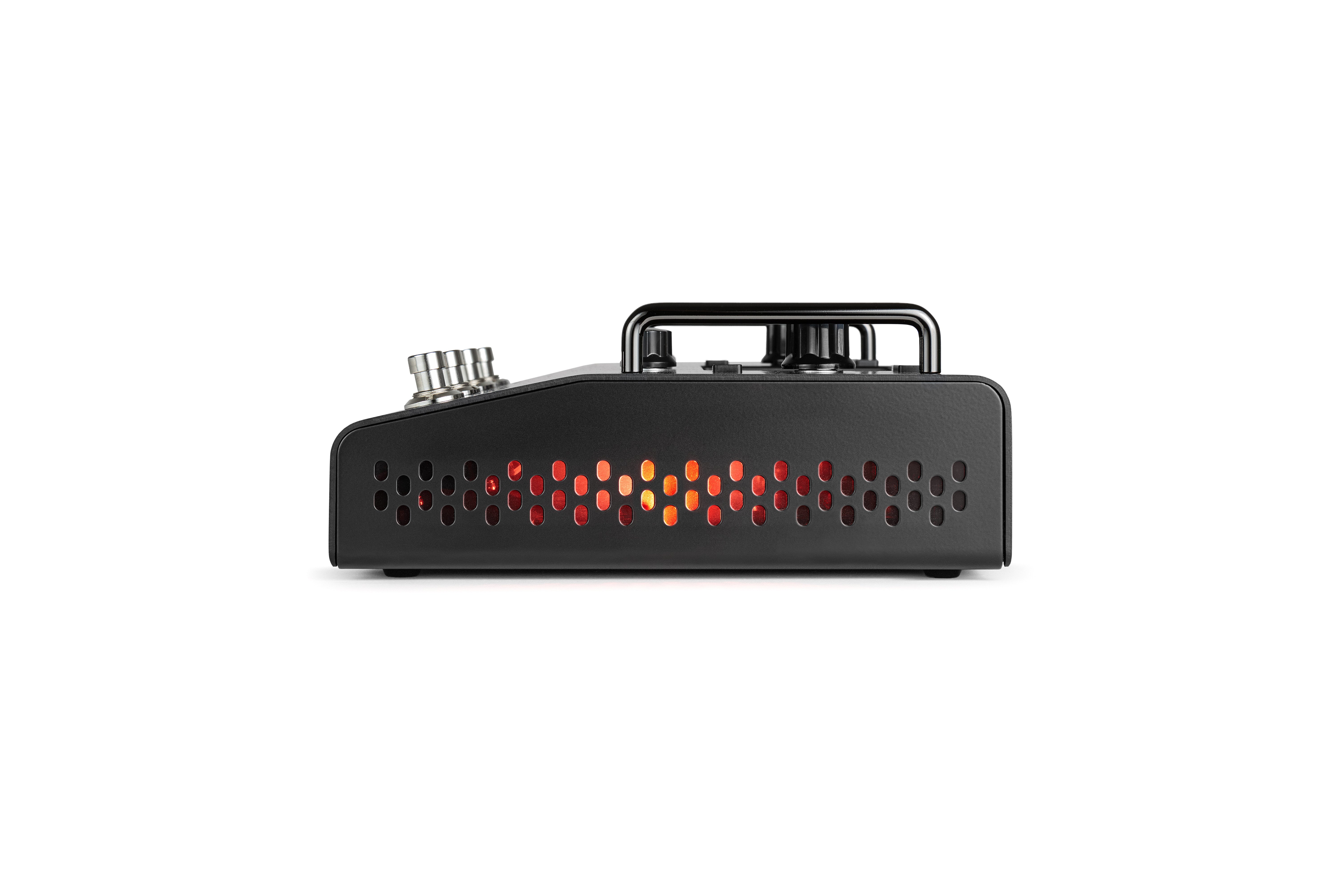 Black effects pedal side view with vent holes glowing red and orange, three silver control knobs, and a raised black handle on top.