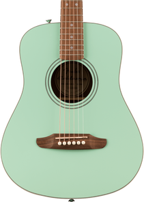 A seafoam green Fender acoustic guitar with a round sound hole, wooden bridge, white pin pegs, and six steel strings.
