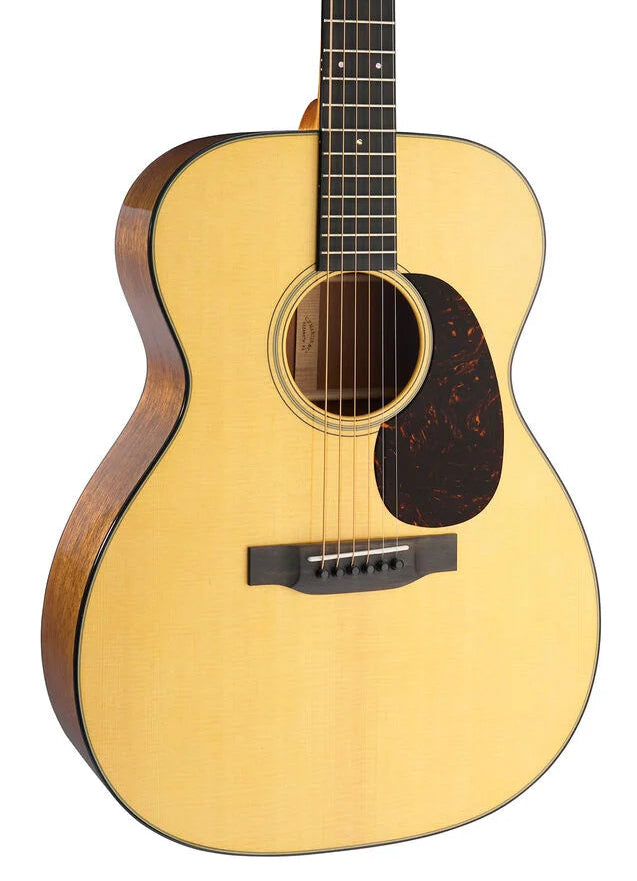 Acoustic guitar with a light-colored top, dark wooden sides, black pickguard, six strings, and a round sound hole.