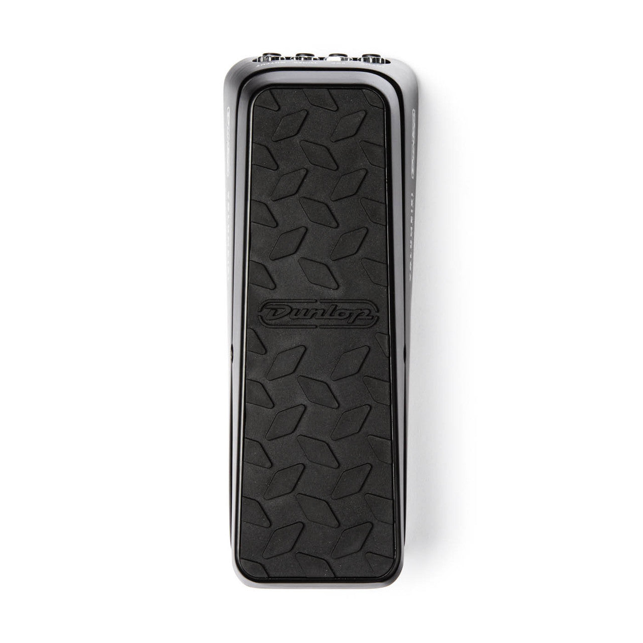 Pédale d'effet guitare rectangulaire, surface noire antidérapante avec motif losange et logo Dunlop au centre, bords métalliques chromés.