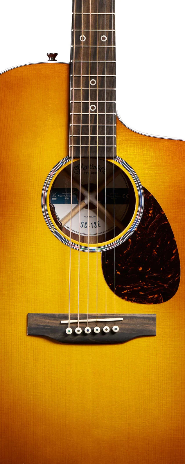 Sunburst acoustic guitar with six strings, circular sound hole, tortoiseshell pickguard, dark bridge, and dot inlays on a rosewood fretboard.