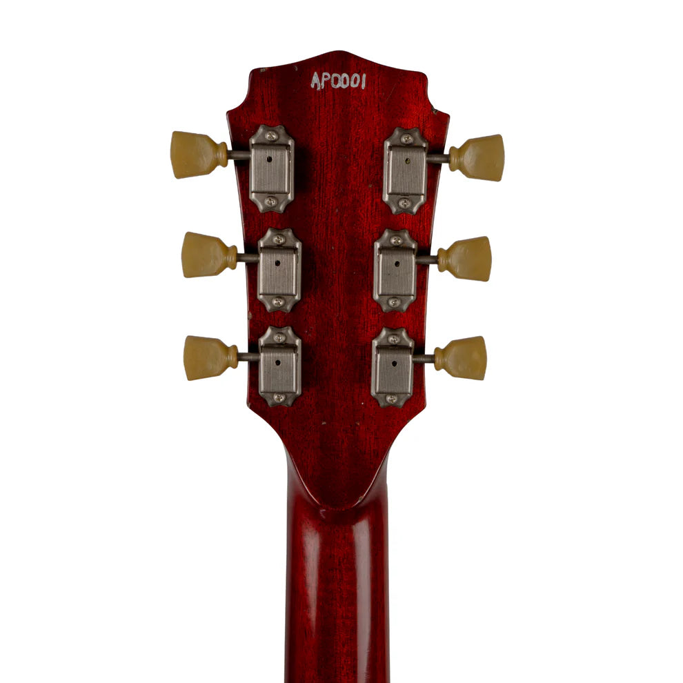 Red electric guitar headstock rear view showing six vintage-style tuners and serial number AP0001 stamped at the top.