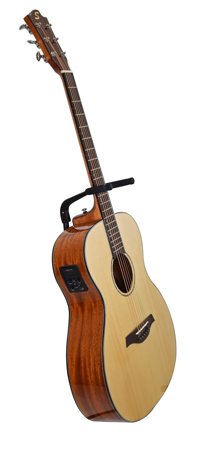 Light wood top acoustic guitar with dark wood sides, cutaway body, six tuning pegs, onboard electronic controls, and a capo clamped on the neck.