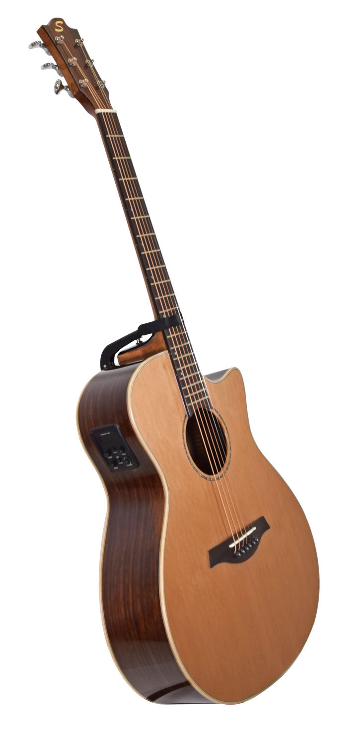 Natural wood acoustic guitar with a cutaway body, electronic controls on the side, and a capo clipped onto the neck.