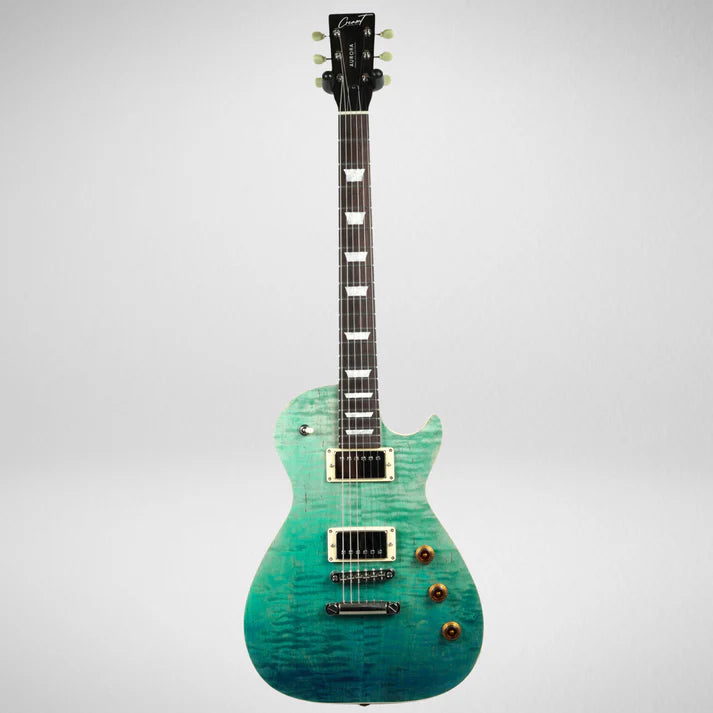 Single-cutaway electric guitar with a glossy turquoise and green finish, two humbucker pickups, three amber control knobs, and block inlays on the fretboard.