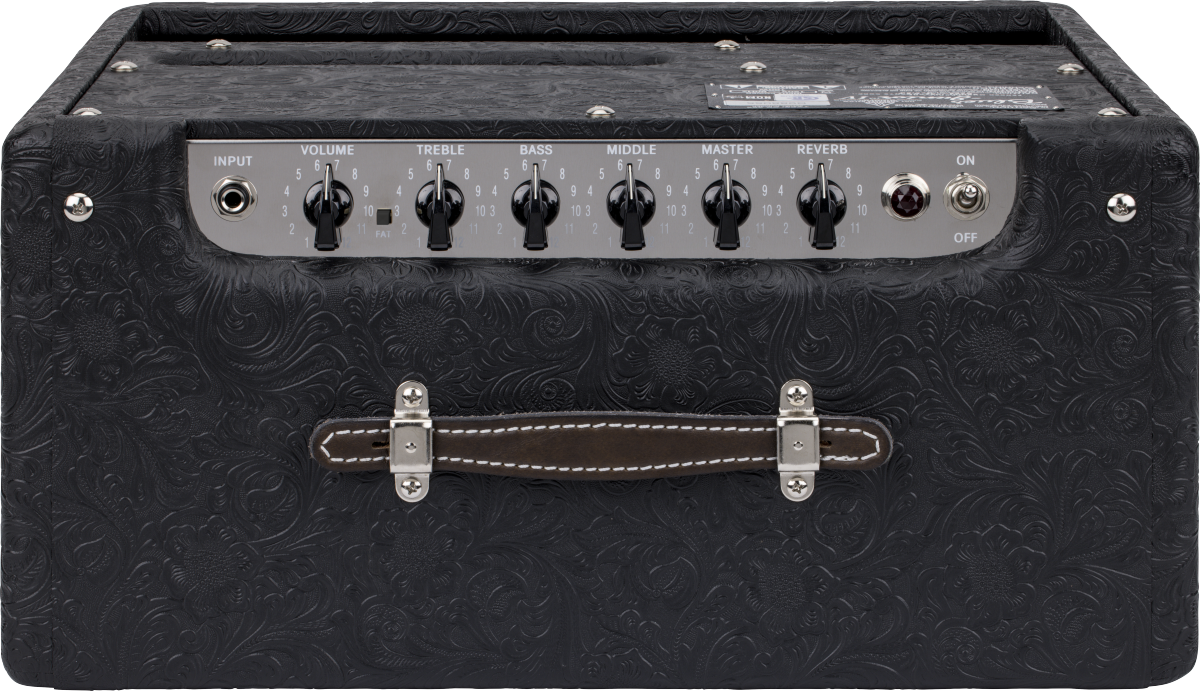 Black amplifier with floral textured covering, six control knobs, input jack, on/off switch, and a brown handle with white stitching on top.