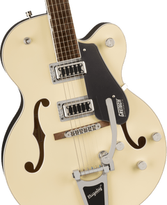 Cream-colored Gretsch electric guitar with two chrome pickups, f-holes, a black pickguard, control knobs, and a Bigsby tremolo arm.
