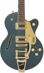 Metallic green electric guitar with gold hardware, two pickups, a Bigsby-style tremolo, and f-shaped sound holes on the body.