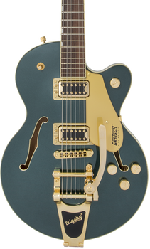 Metallic green electric guitar with gold hardware, two pickups, a Bigsby-style tremolo, and f-shaped sound holes on the body.