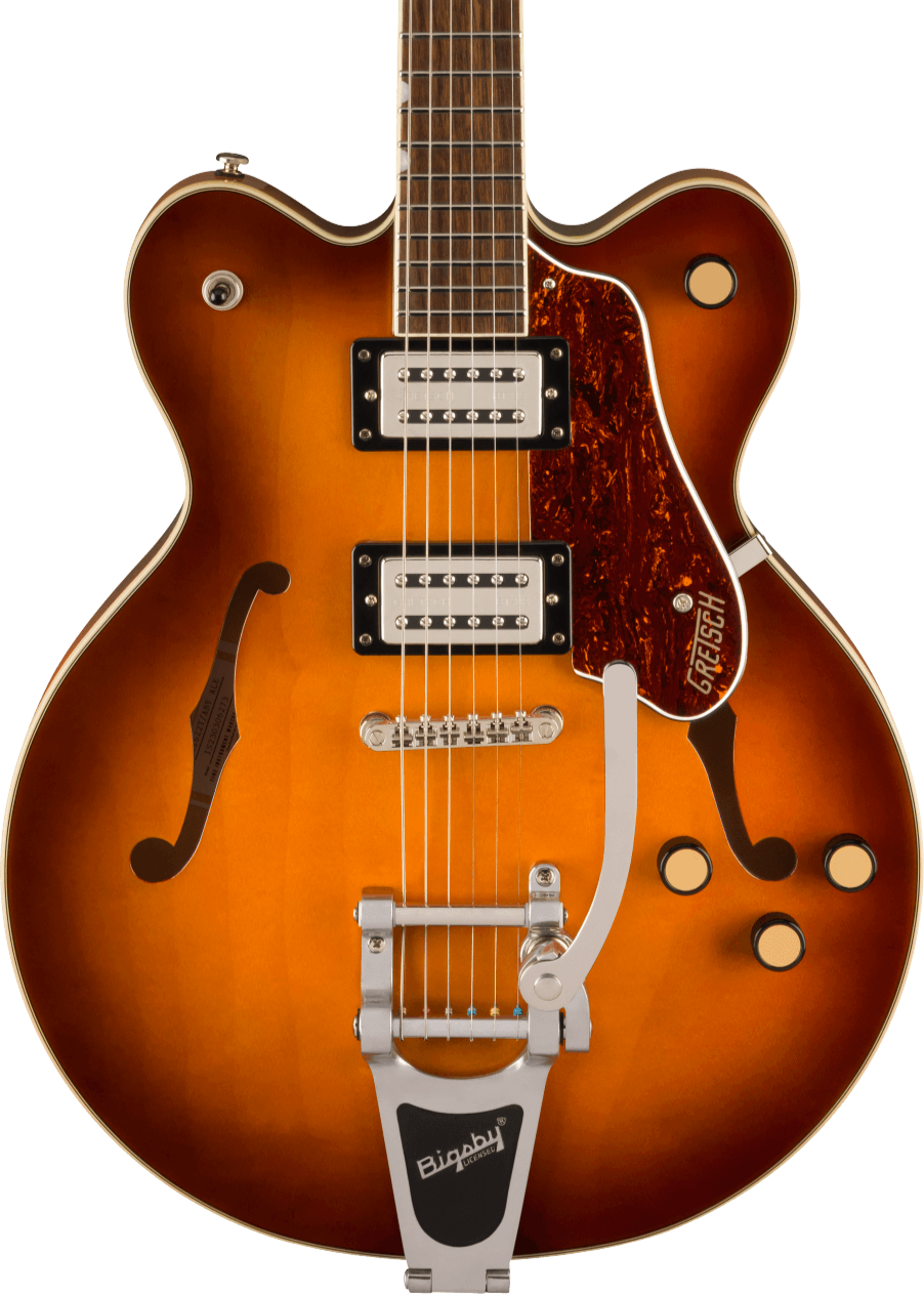 Sunburst electric guitar with two pickups, four knobs, f-shaped sound holes, tortoiseshell pickguard, and a silver Bigsby tremolo tailpiece.
