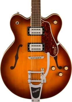 Sunburst electric guitar with two pickups, four knobs, f-shaped sound holes, tortoiseshell pickguard, and a silver Bigsby tremolo tailpiece.