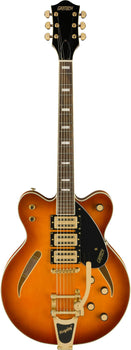 Gretsch electric guitar with a sunburst finish, gold hardware, three pickups, black pickguard, f-holes, and a Bigsby tremolo tailpiece.