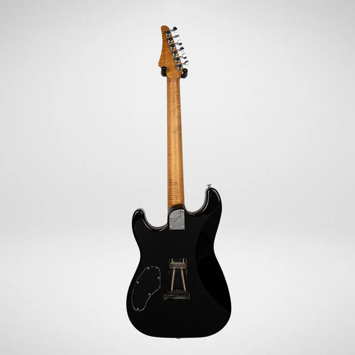 Black electric guitar seen from the back, showing a natural wood neck and metal hardware, with electronic and spring cavity covers visible.