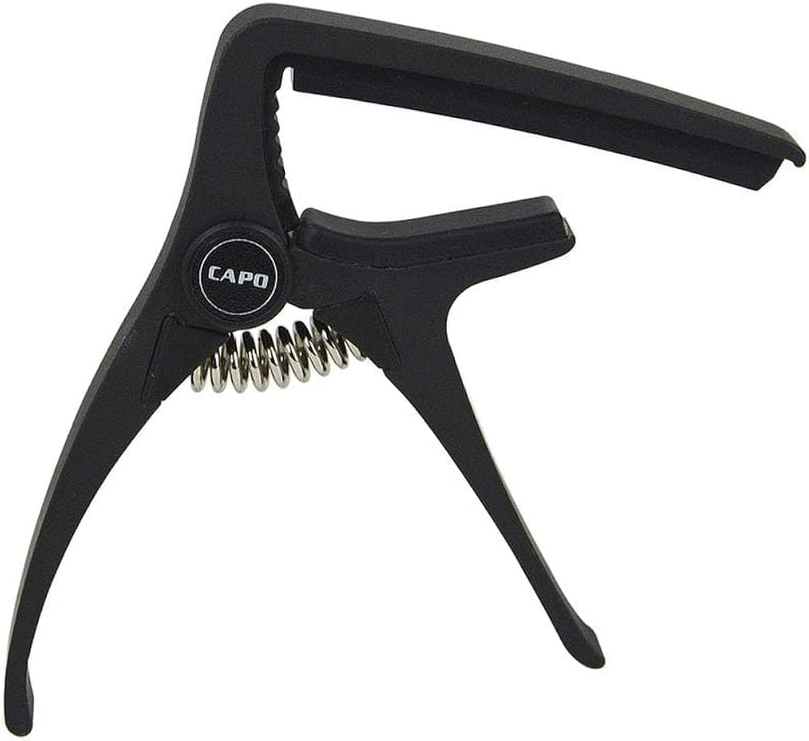 Black guitar capo with a spring-loaded clamp design and the word "CAPO" printed on a circular section near the hinge.