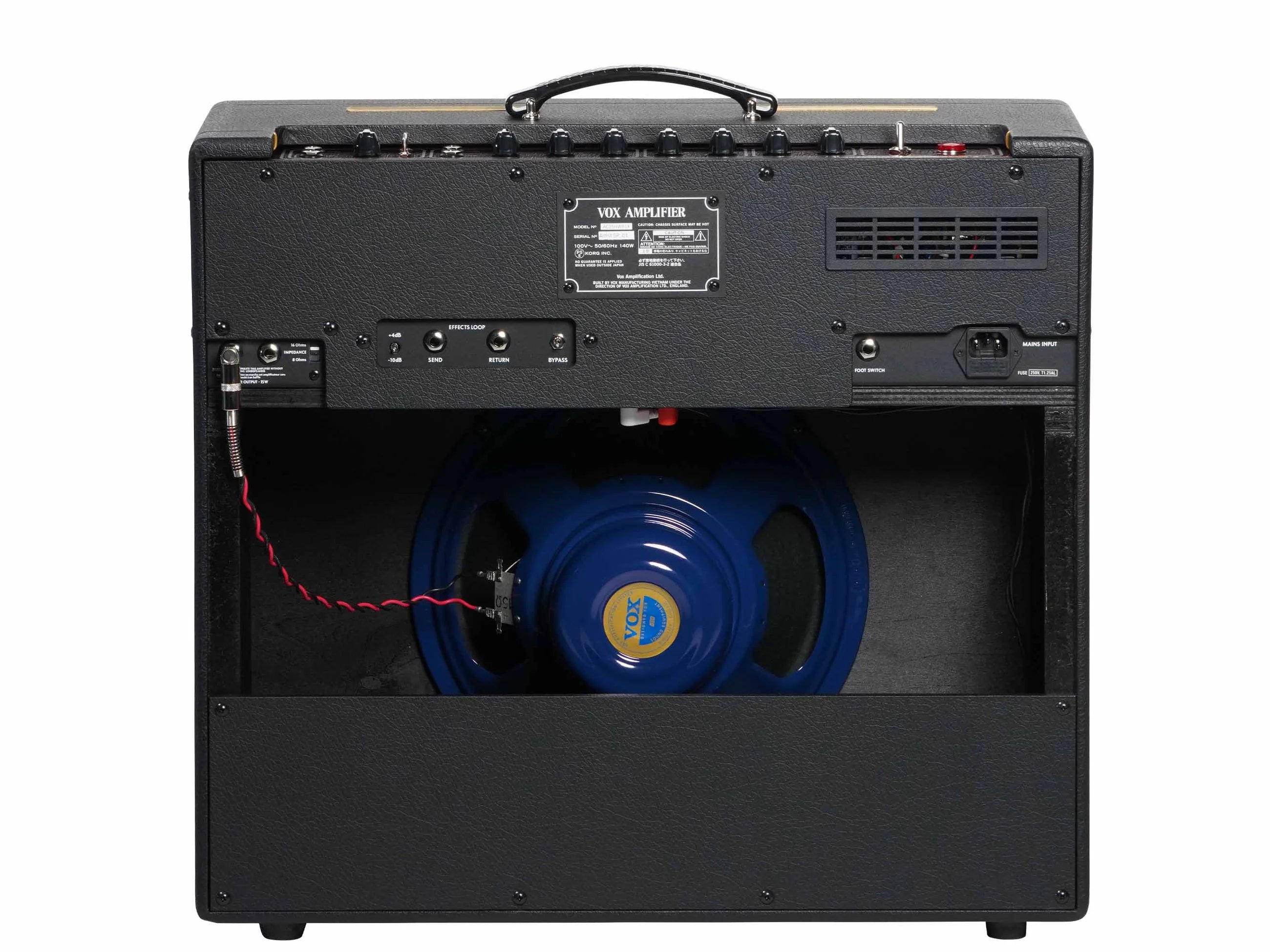 Rear view of a Vox guitar amplifier showing control panel, ports, black casing, and an exposed blue speaker with red and black wires.