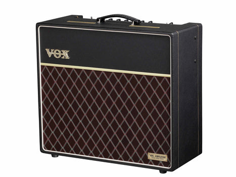 Black VOX guitar amplifier with a gold logo, carrying handle, and a front panel featuring a maroon diamond-patterned grille.