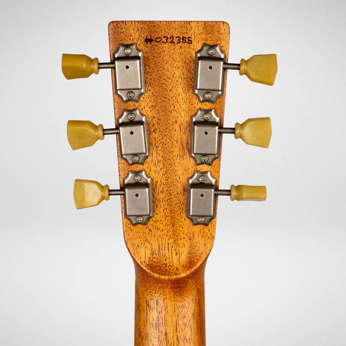 Back of an electric guitar headstock showing six vintage-style tuning pegs with yellow buttons and a serial number stamped on the wood.