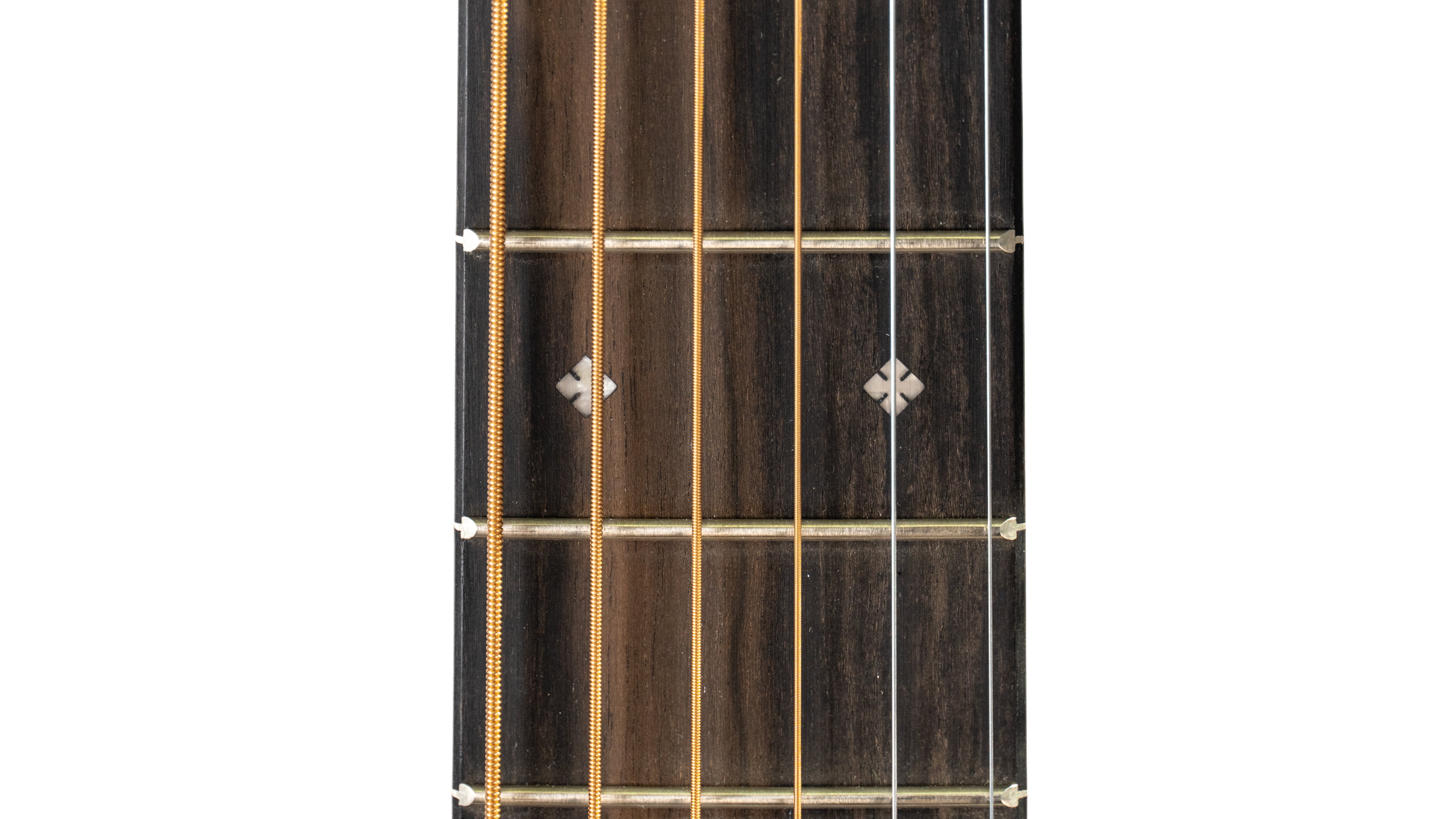 Close-up of an acoustic guitar fretboard showing six strings, two small diamond-shaped inlays, and three metal frets on dark wood.