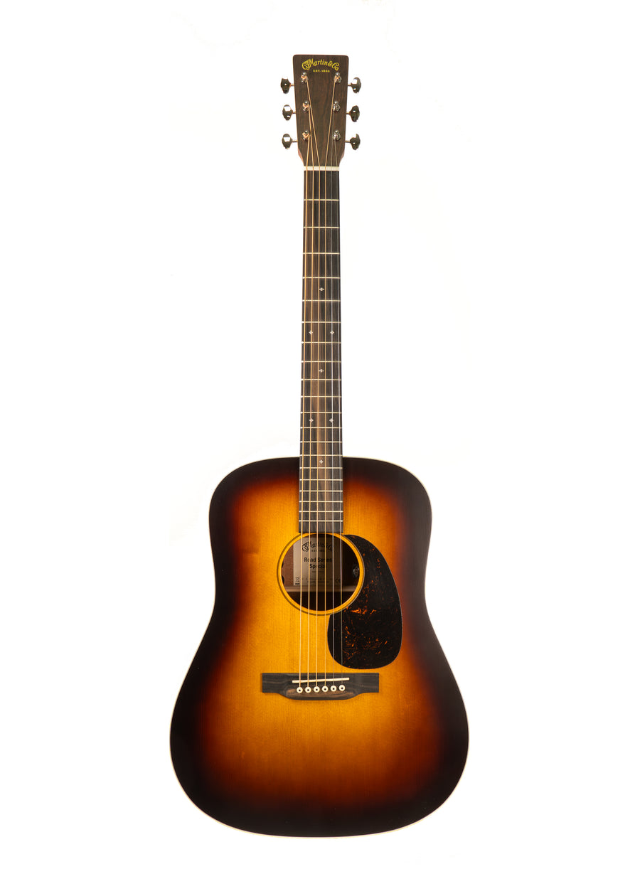 Acoustic guitar with a dark sunburst finish, six strings, a black pickguard, and a rounded body with a narrow neck.