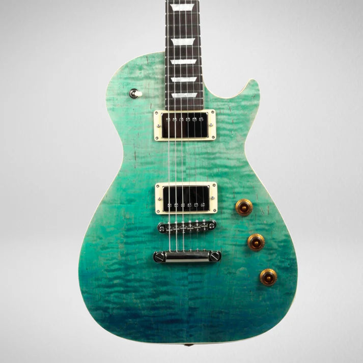 Electric guitar with a single cutaway body, turquoise to blue gradient finish, two humbucker pickups, and three amber control knobs.
