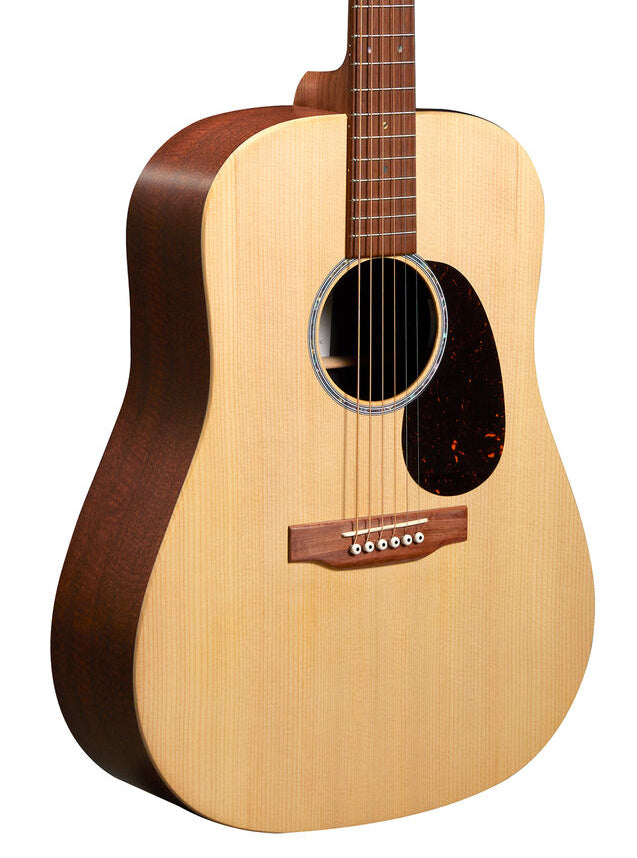 Acoustic guitar with a light wood top, dark wood sides and back, six strings, circular sound hole, and a dark pickguard below the strings.