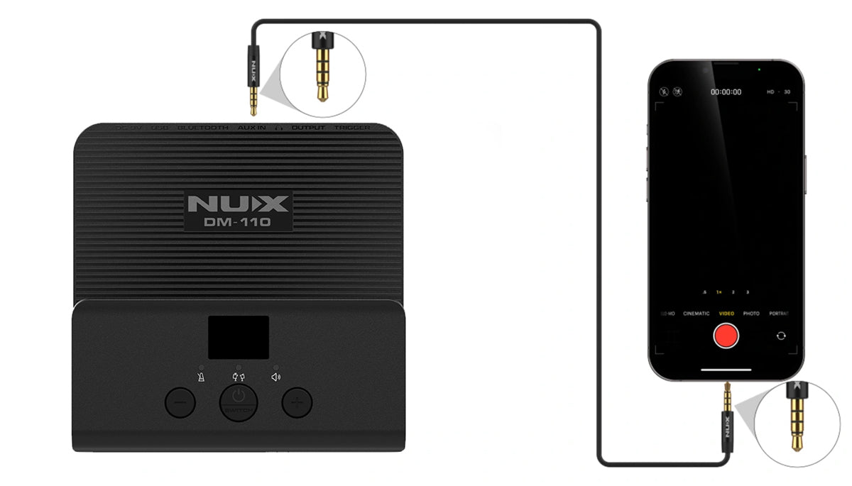 A NUX DM-110 electronic drum module is connected to a smartphone via an audio cable with mini-jack plugs, ready for recording.