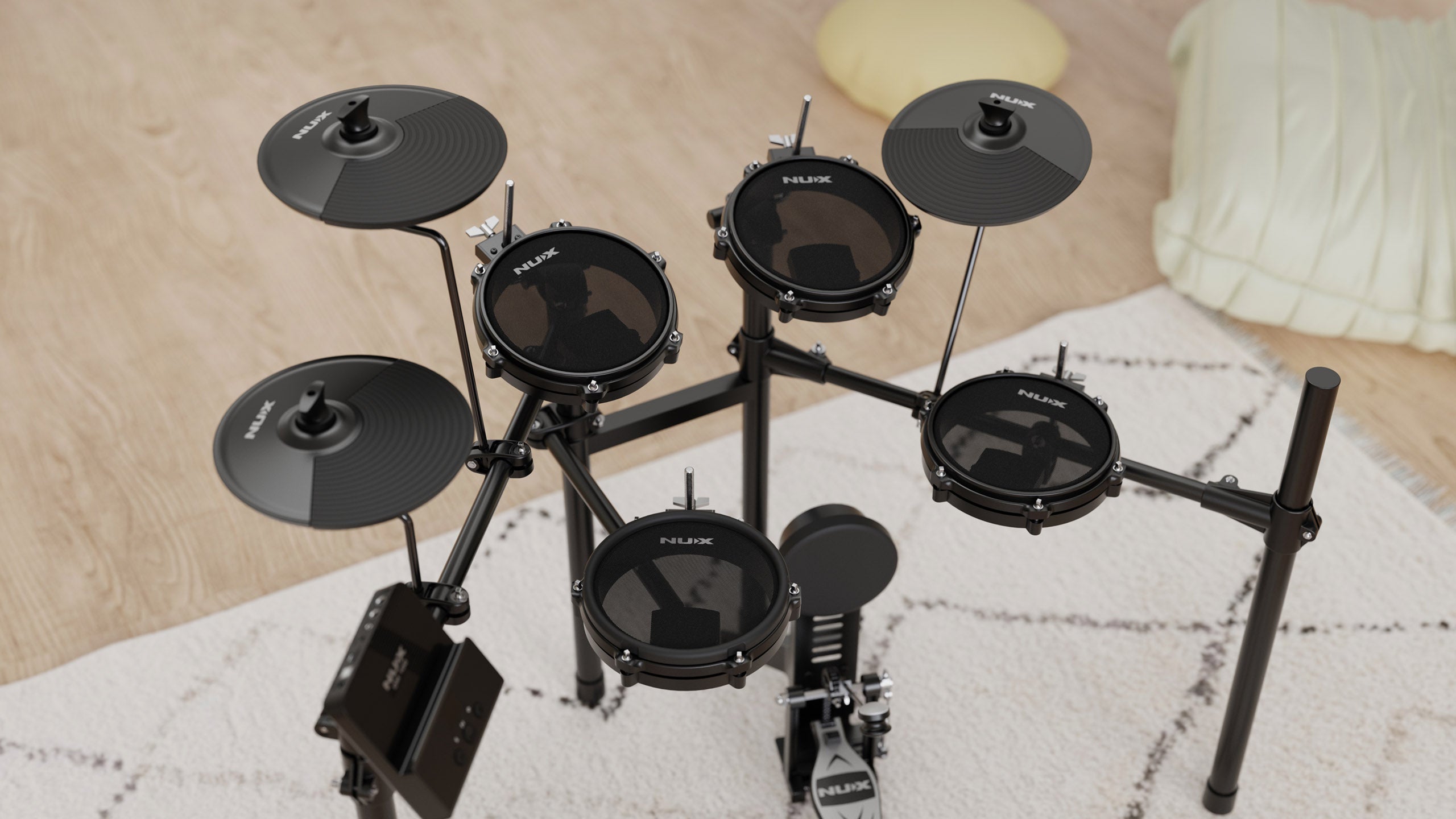 Five mesh drum pads and three black rubber cymbals mounted on a metal frame; electronic drum set placed on a rug in a room with light wood flooring.