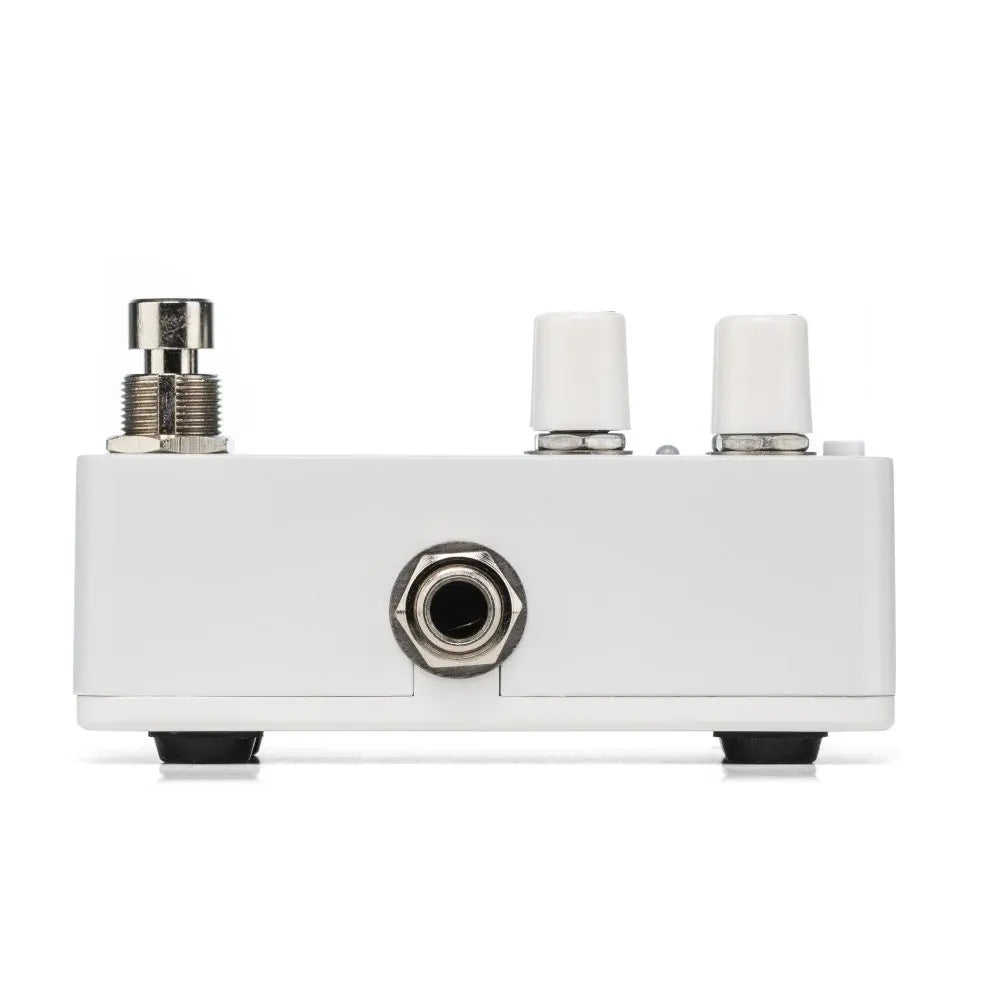 Compact white FX pedal with a metal footswitch, two white control knobs, and a single input jack on the front panel.