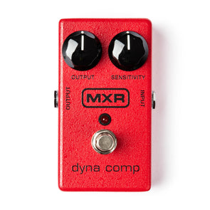 Bright red MXR Dyna Comp FX pedal with two black knobs labeled Output and Sensitivity, a silver footswitch, and a small red LED indicator.