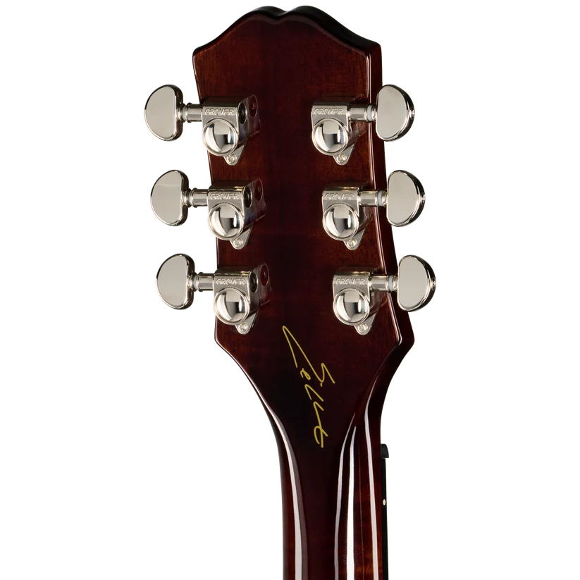 Six chrome tuning pegs on a glossy dark wood acoustic guitar headstock, with a gold signature near the base.