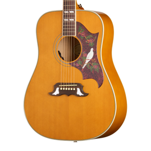 Natural finish acoustic guitar with a decorative pickguard featuring a white bird and floral pattern, and unique white inlays on the bridge.