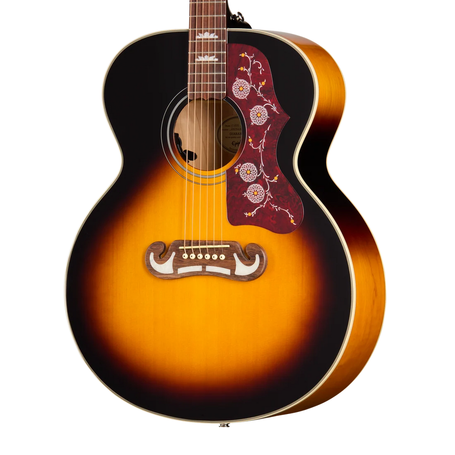 Sunburst acoustic guitar with a red floral pickguard and an ornate wooden bridge, featuring six strings and pearl inlays on the fretboard.