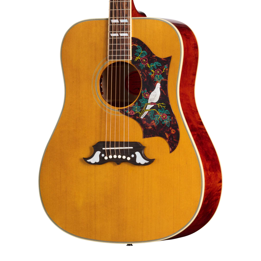 Acoustic guitar with a natural wood finish, floral pickguard featuring a white dove, and decorative white inlays on the bridge.