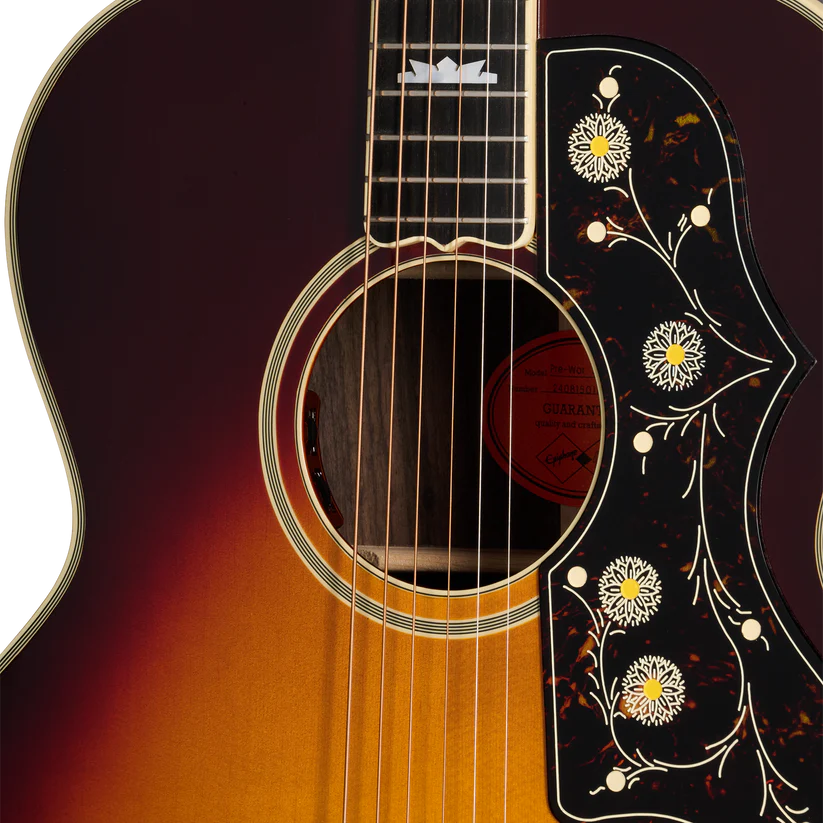 Acoustic guitar body with sunburst finish and a pickguard featuring white flower and vine inlays, strings and sound hole visible.