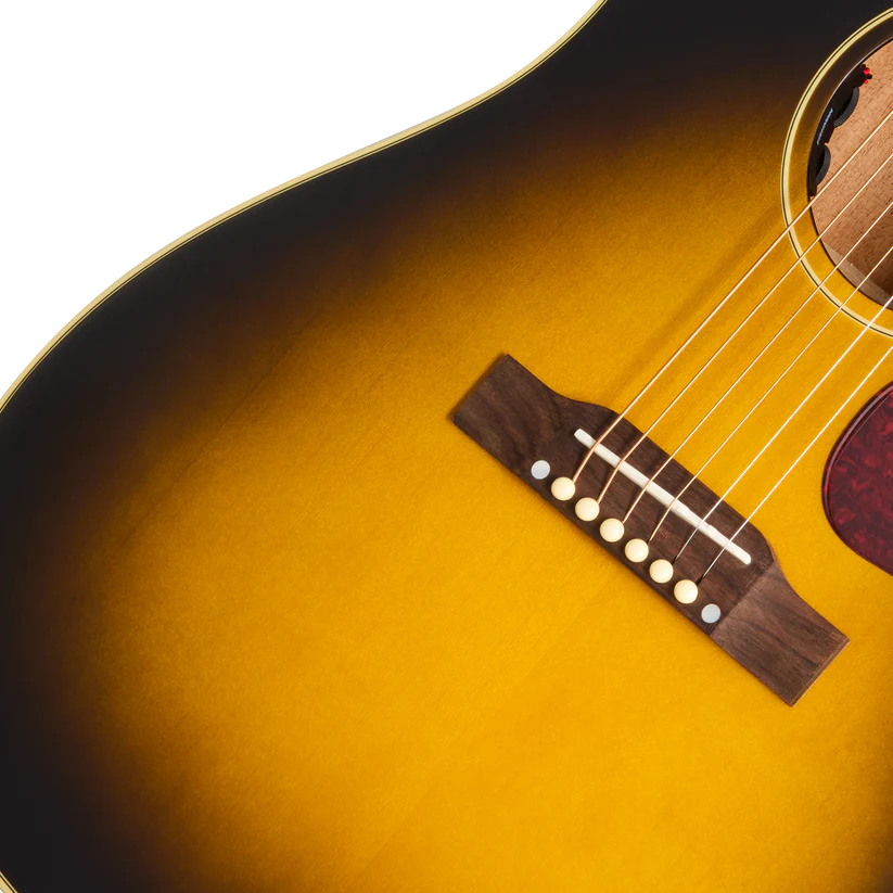 Sunburst finish acoustic guitar body showing the wood bridge, six strings, and part of the pickguard.