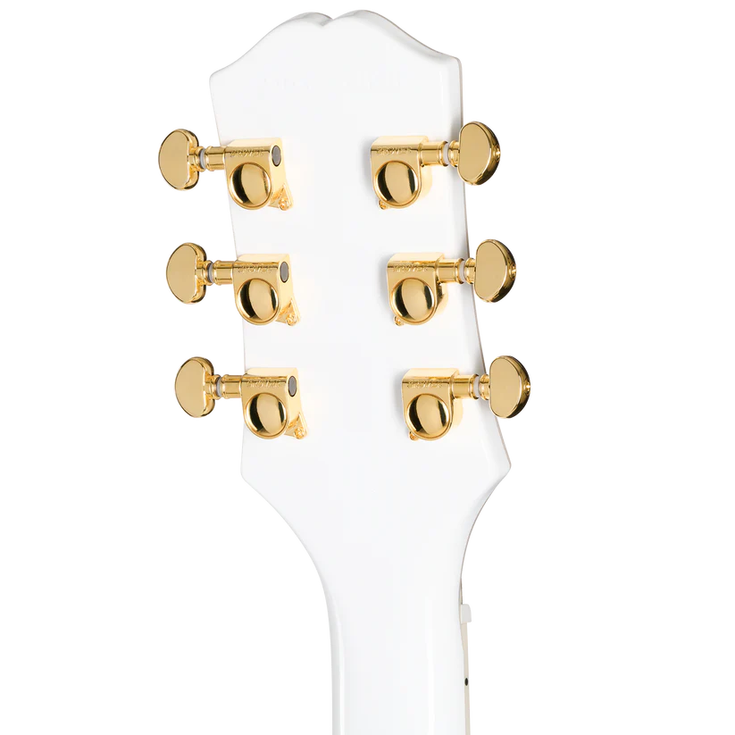 Tête d'une guitare électrique blanche avec six mécaniques dorées alignées trois de chaque côté.