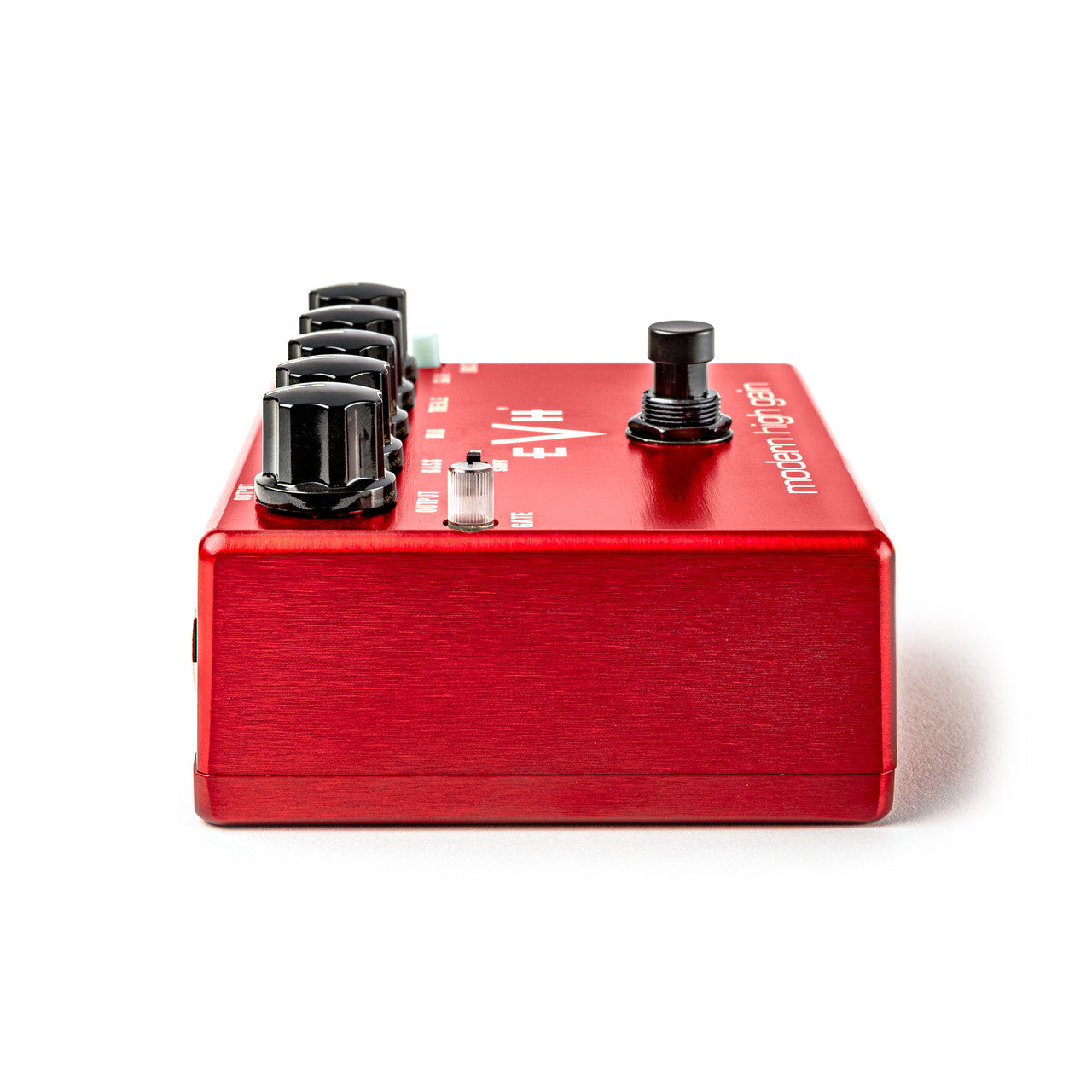 Red FX pedal with four large black knobs, one smaller silver knob, and a black footswitch on top, viewed from a side angle.