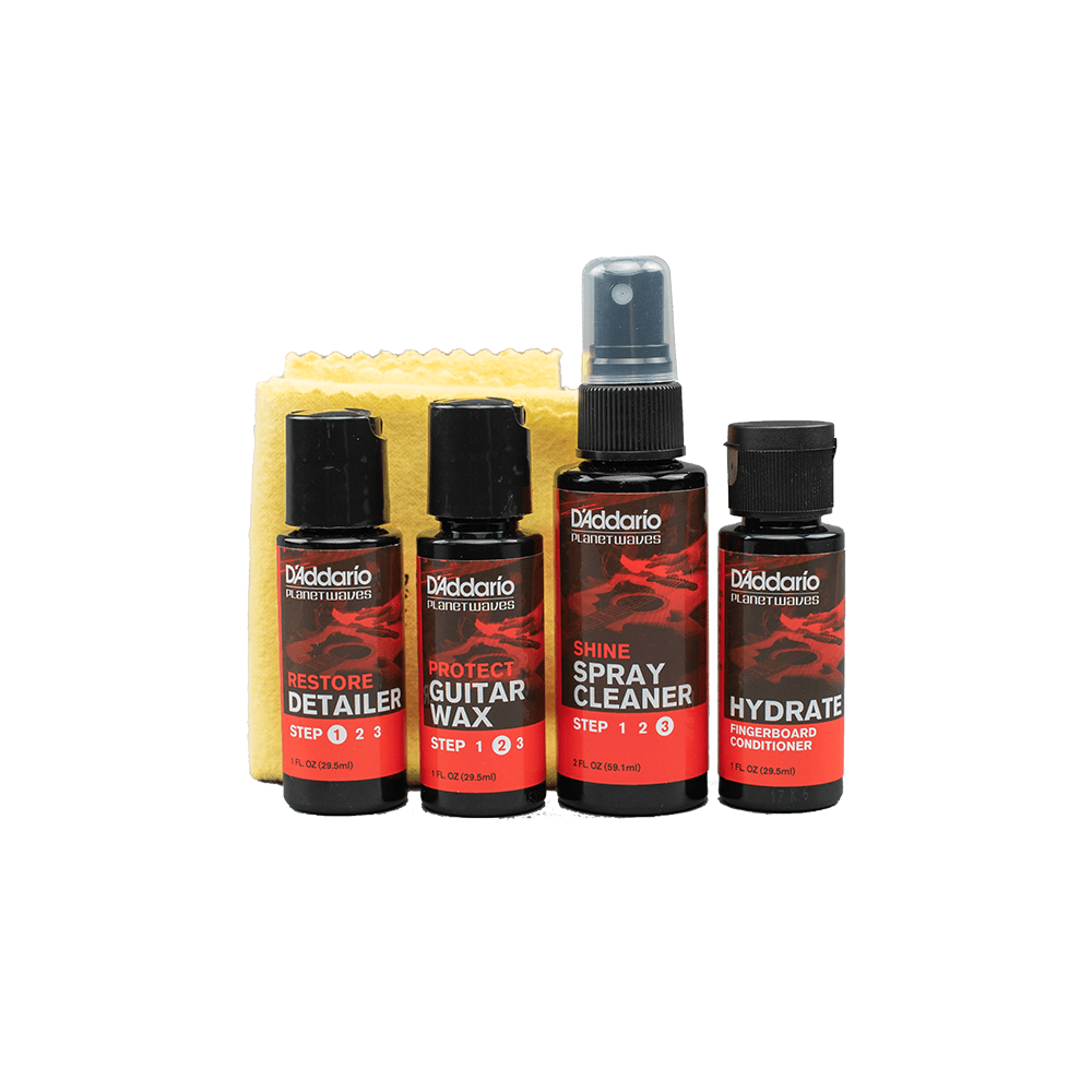 Four D'Addario guitar care bottles—detailer, wax, spray cleaner, hydrator—are lined up with a yellow cleaning cloth behind them.