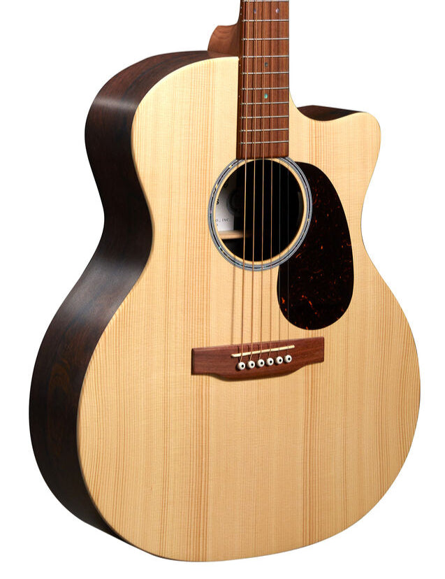 Light wood acoustic guitar with dark sides, a rounded cutaway, six strings, a circular sound hole, and a dark pickguard below the strings.