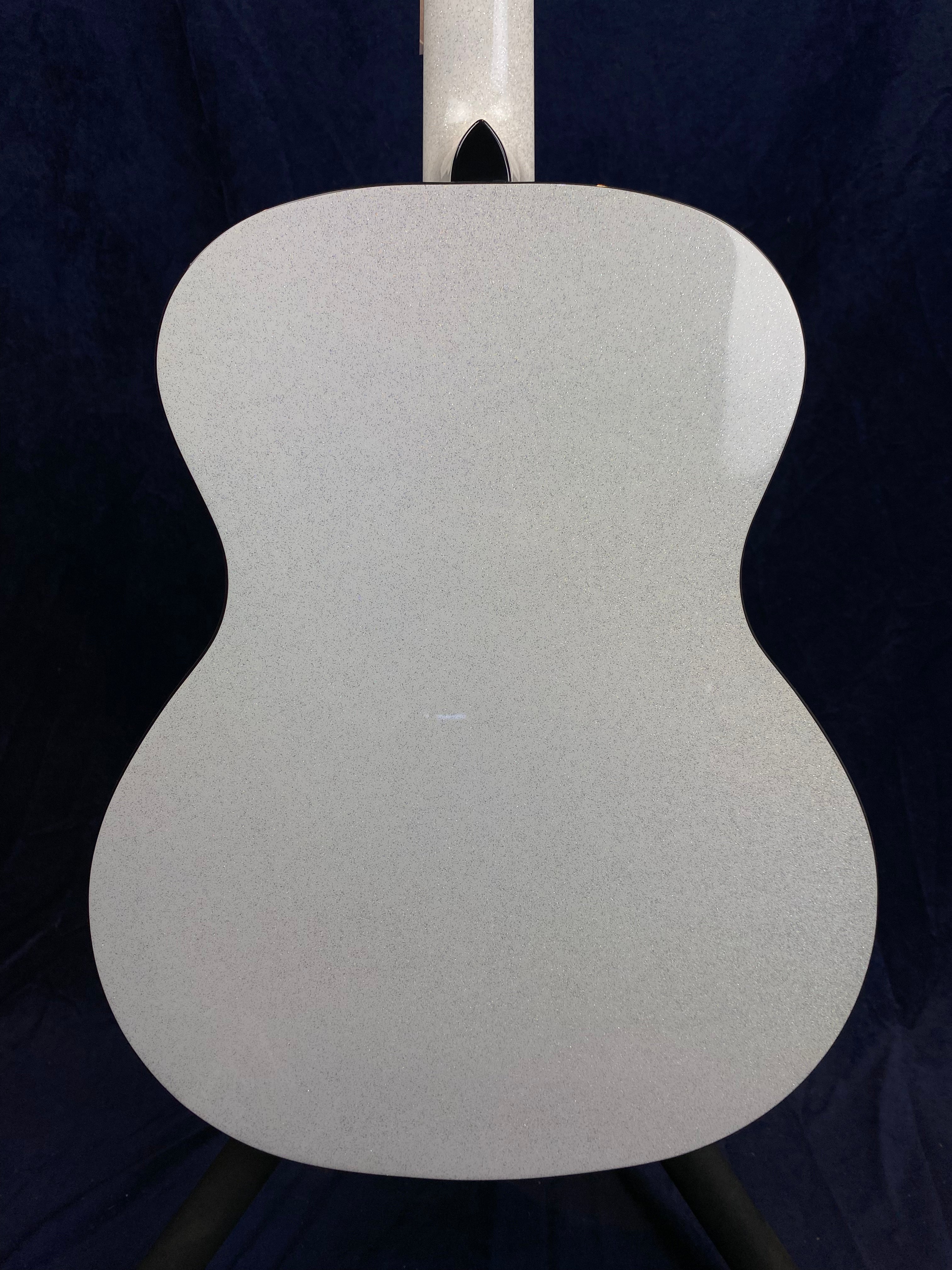Back view of an acoustic guitar with a smooth, glossy light gray finish and a curved body shape, shown against a dark background.
