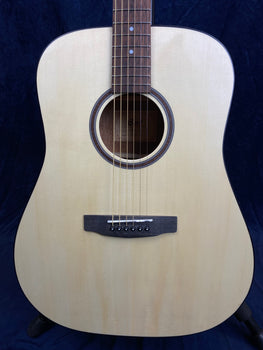 Natural wood acoustic guitar with a light-colored top, round sound hole, six strings, and a dark wood bridge and fretboard.