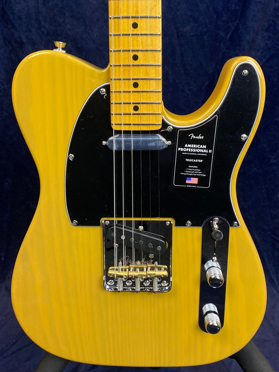 Yellow Fender American Professional II Telecaster electric guitar with a black pickguard, chrome hardware, and a maple neck.