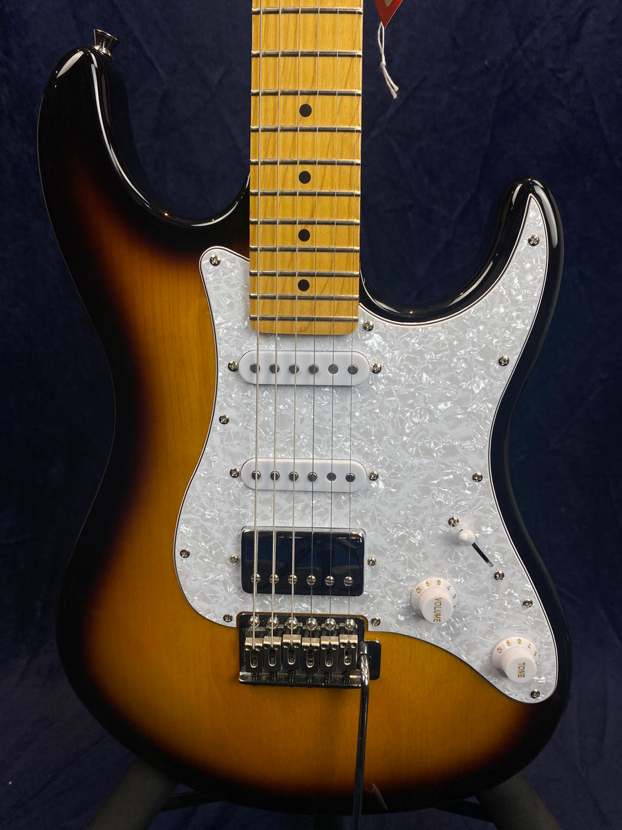 Sunburst electric guitar with a maple neck, three pickups including a humbucker, white pearloid pickguard, and three white control knobs.