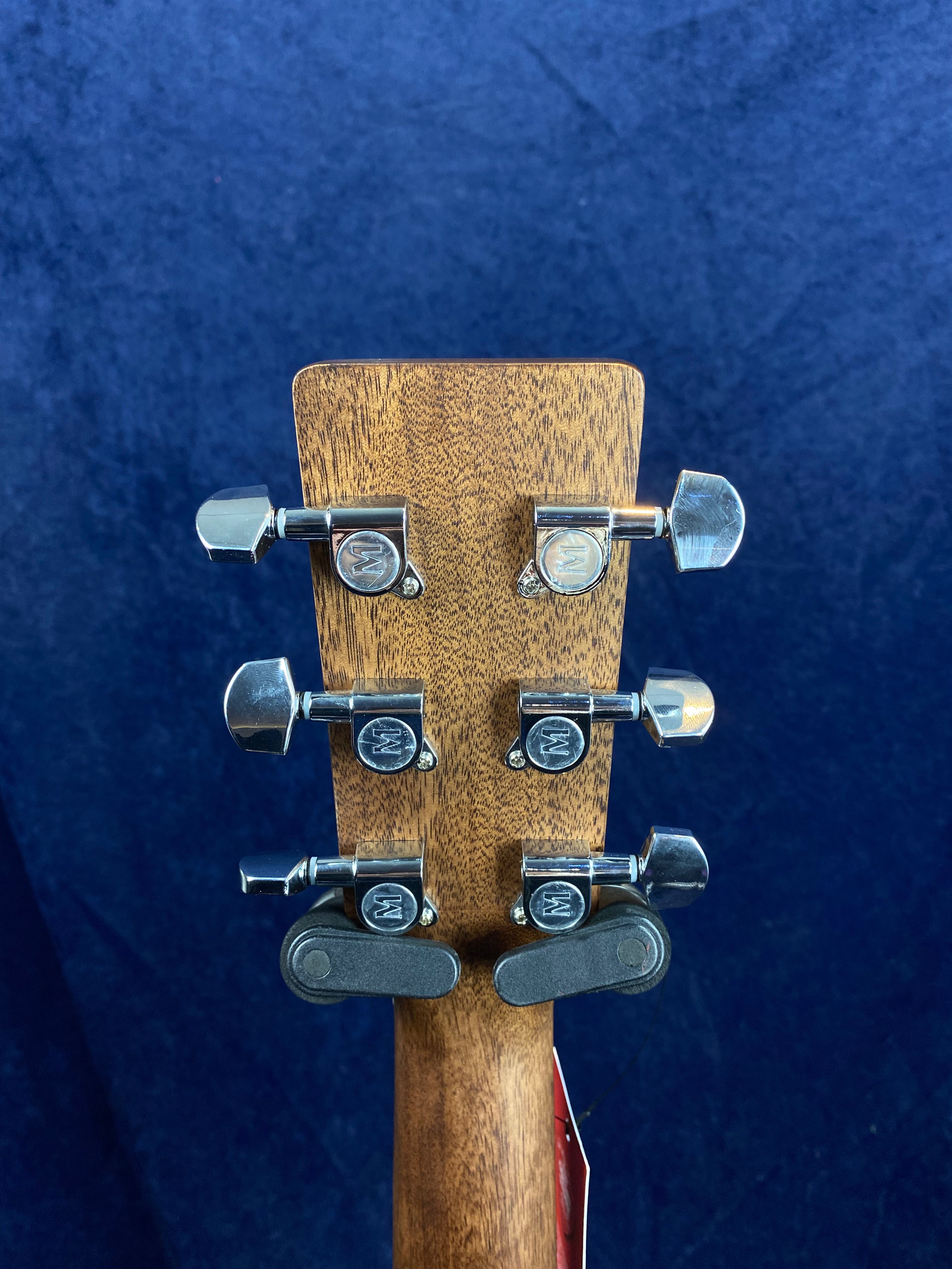 Six silver tuning pegs on the back of a wooden acoustic guitar headstock, evenly spaced in two rows of three.