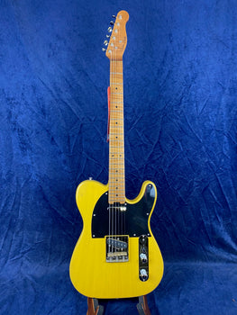 Yellow electric guitar with a single cutaway, black pickguard, two pickups, chrome controls, and a maple neck, displayed upright against a blue background.